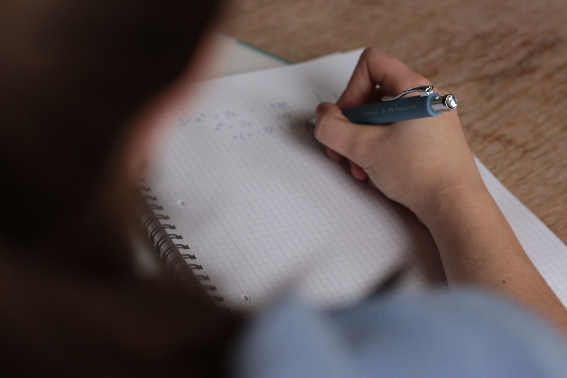 A notebook with handwritten copywriting notes, pen resting on the open page.